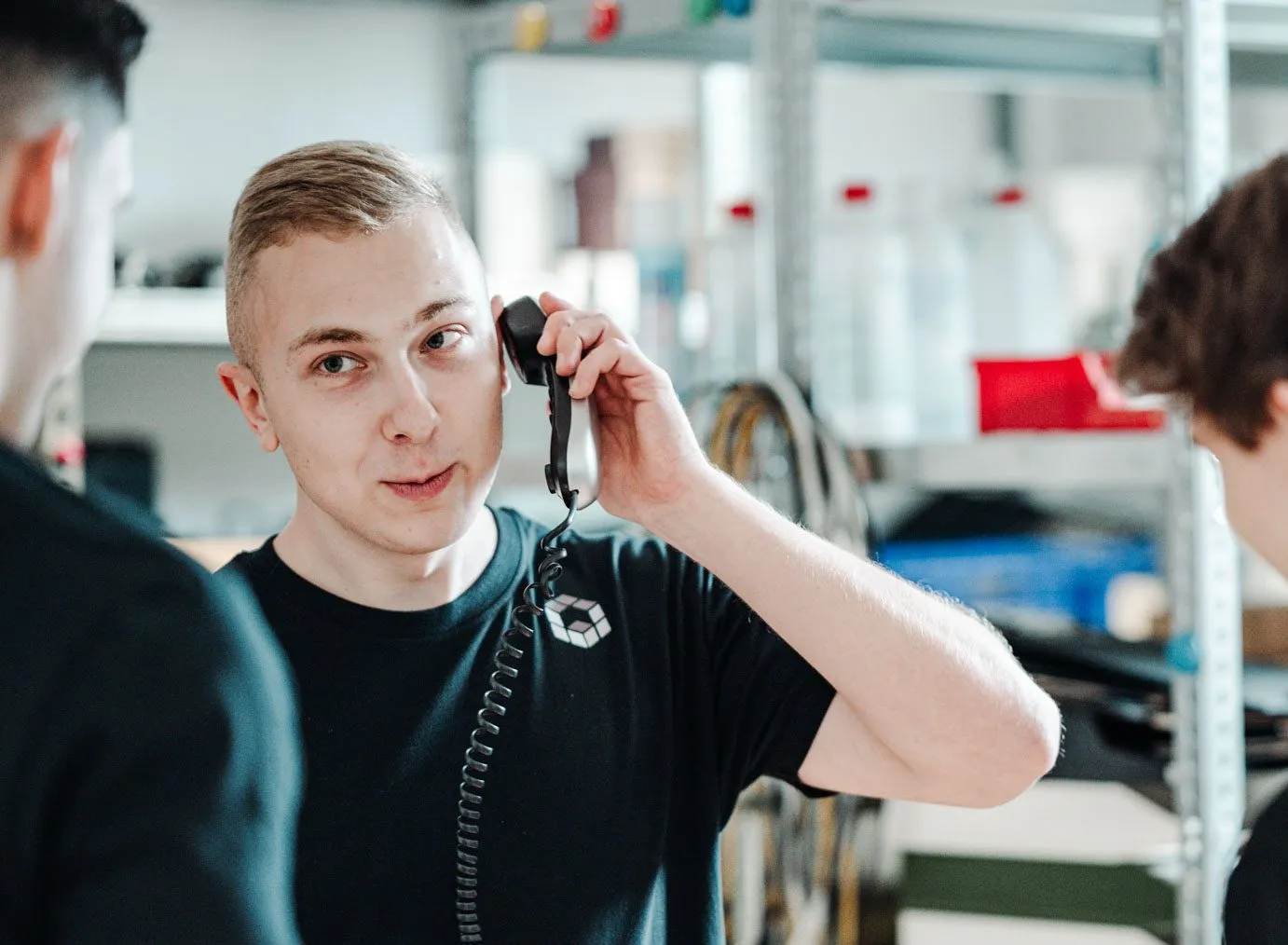 Mitarbeiter telefoniert mit einem Telefonhörer im Lager